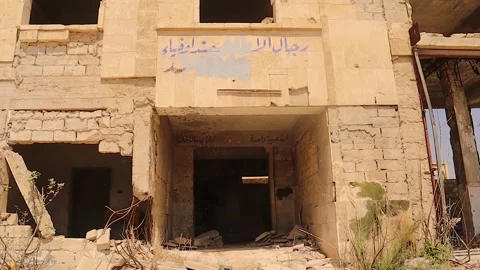 War-damaged security building in Aleppo Syria with Arabic graffiti remains Stock Footage 319000650
