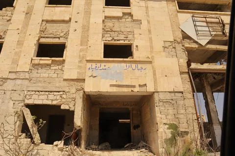 War-damaged security building in Aleppo Syria with Arabic graffiti remains Stock Photos