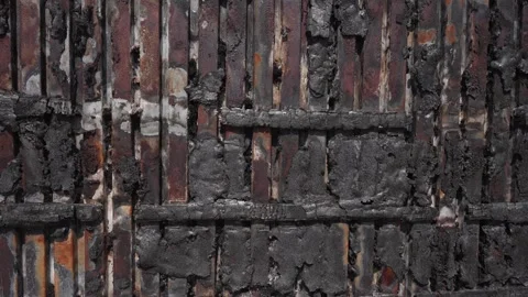 War-Damaged Wall with Burned Marks and Shattered Structure. Concept Ravages of Stock Footage 263825718