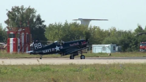 War II carrier-based fighter Chance Vought F4U Corsair moves along taxiway. Stock Footage 115012762