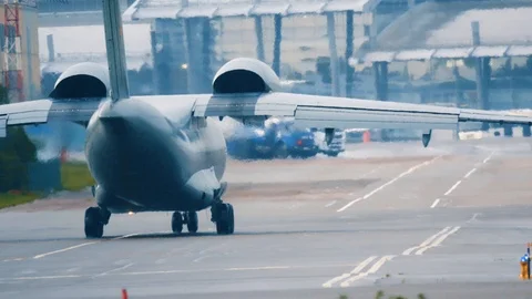War plane (combat plane) is taxiing on taxiway after landing in rainy weather Stock Footage 112633645