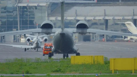War plane (combat plane) is taxiing on a airfield after landing in rainy weather Stock Footage 112634876