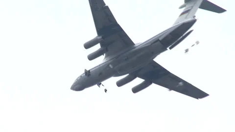 War plane. Skydivers jump out of the plane. Parachute deployment. Stock Footage 119629267