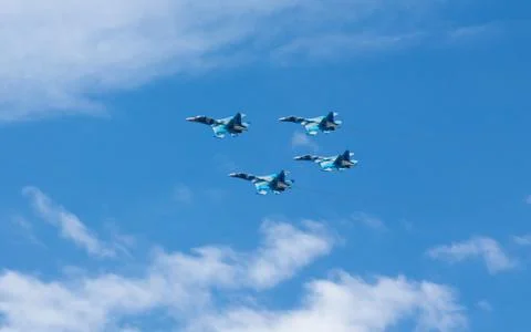 War planes in blue sky with clouds at the victory parade in the capital of Stock Photos