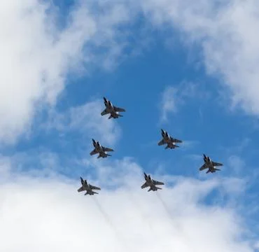 War planes in blue sky with clouds at the victory parade in the capital of Stock Photos