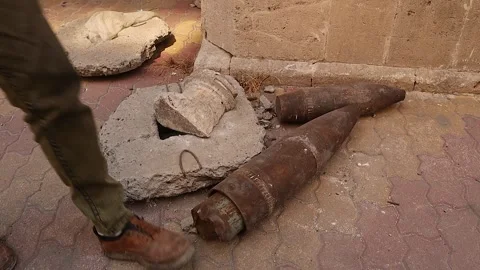 War remnants and unexploded shells on Aleppo street, syria Stock Footage 318352266