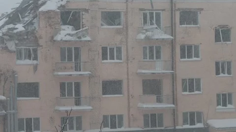 War in Ukraine, Broken windows, estroyed building, winter day, first snow Stock Footage 258661906
