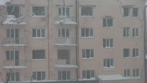 War in Ukraine, Broken windows, estroyed building, winter day, first snow Video stock 258662216