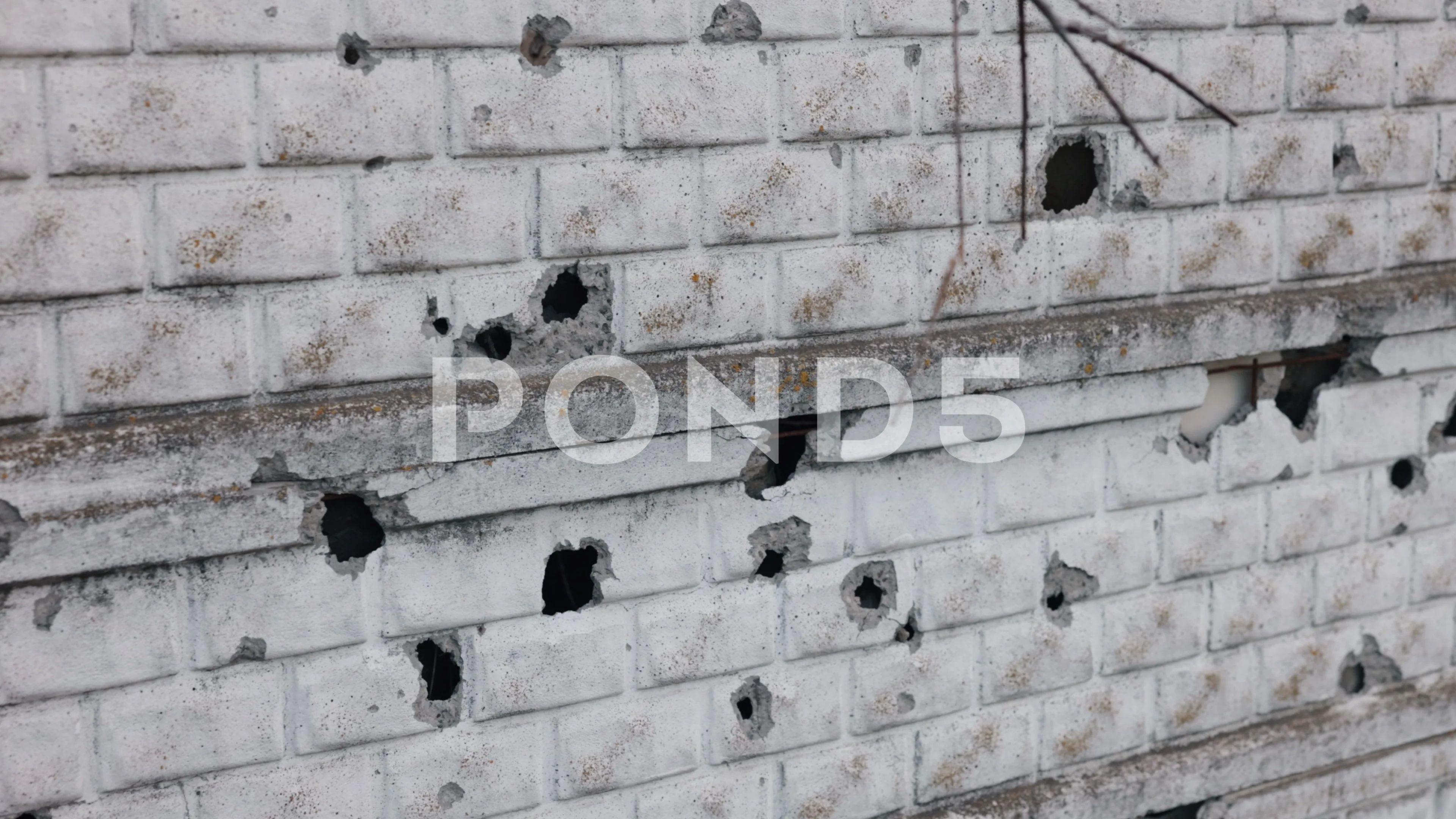 bullet holes in brick wall