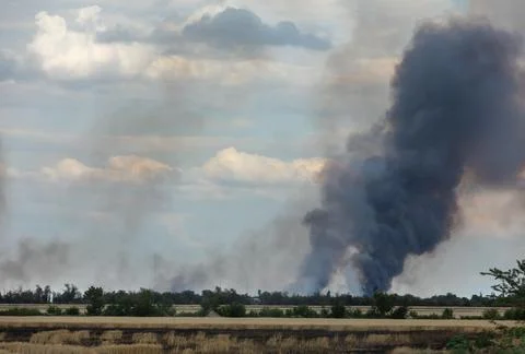 War in Ukraine. Fields of wheat in fire Stock Photos