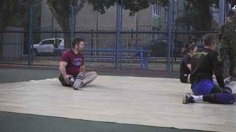 War veterans play sit-down volleyball on the court. Handicapped in sport. 스톡 동영상 120704279