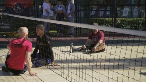 War veterans play sit-down volleyball on the court. Handicapped in sport. 스톡 동영상 120704568