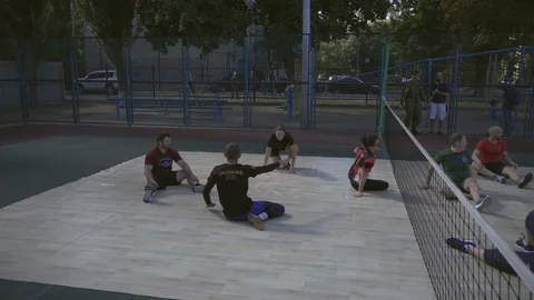 War veterans play sit-down volleyball on the court. Handicapped in sport. 스톡 동영상 120704699