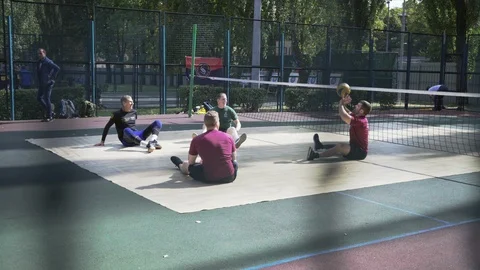 War veterans play sit-down volleyball on the court. Handicapped in sport. 스톡 동영상 120776220