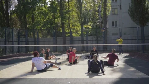 War veterans play sit-down volleyball on the court. Handicapped in sport. 스톡 동영상 120776308
