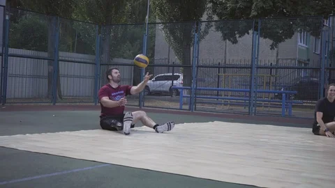 War veterans play sit-down volleyball on the court. Handicapped in sport. 스톡 동영상 121041836