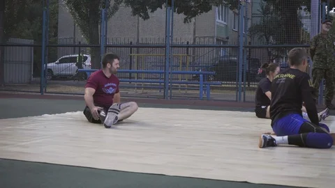 War veterans play sit-down volleyball on the court. Handicapped in sport. 스톡 동영상 121041901