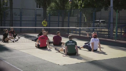 War veterans play sit-down volleyball on the court. Handicapped in sport. 스톡 동영상 121042243