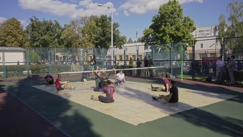 War veterans play sit-down volleyball on the court. Handicapped in sport. 스톡 동영상 121042302