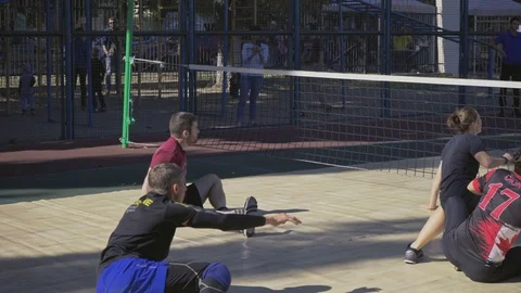 War veterans play sit-down volleyball on the court. Handicapped in sport. 스톡 동영상 121042334