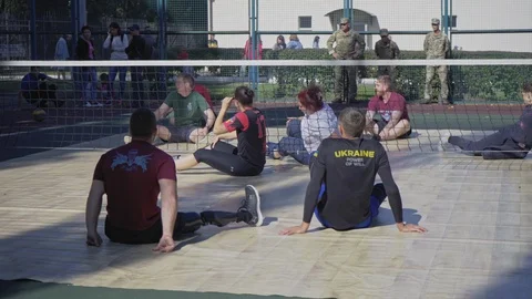 War veterans play sit-down volleyball. Soldiers with prosthetic legs compete. Stock Footage 121560134