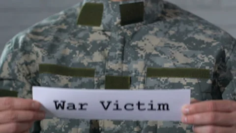 War victim written on paper in hands of male soldier, PTSD concept, closeup Stock Footage 108011533