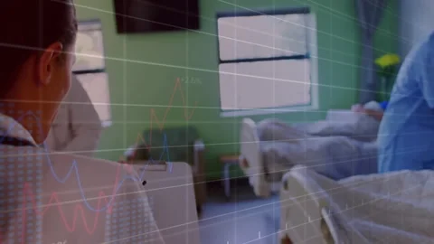 Ward team reacting to data overlays appearing by reviewing patient data and Stock Footage 311901697