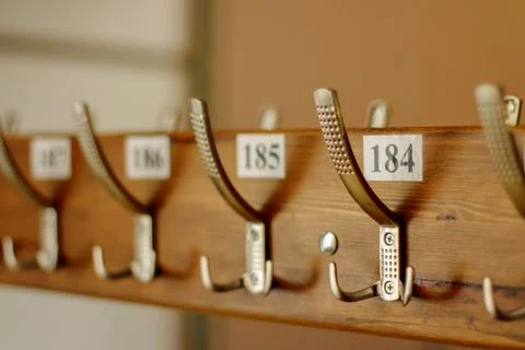 Wardrobe, clothes hooks are numbered. coat rack with hooks for coats and jack Stock Photos