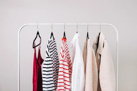 Wardrobe essentials, stylish woman's closing on the rack Stock Photos