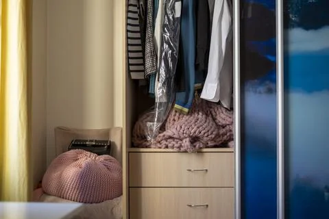 Wardrobe with hanging clothes Stockfoto's