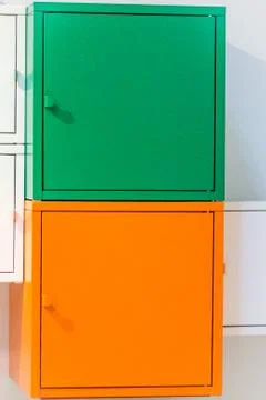 The wardrobe is multicolored. System for storage. A bedside table. Stock Photos