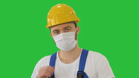Ware the mask! Masked construction man in hardhat on a Green Screen, Chroma Key. Stock Footage 127696781
