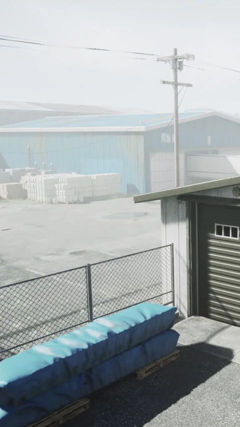 Warehouse area with blue tarps on pallets near a metal building Vídeos de archivo 337975117