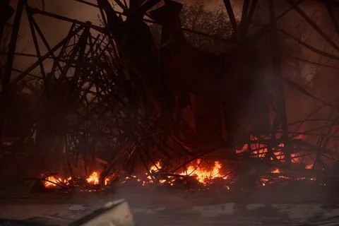 Warehouse burns after drone attack. Russia's war against Ukraine Stock Photos