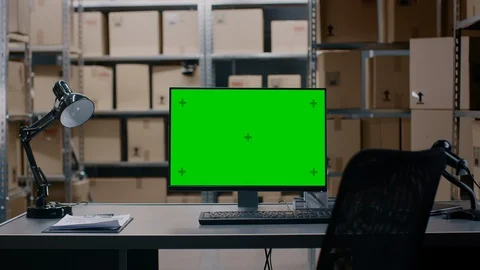 In the Warehouse Computer with Green Mock-up Screen Display Standing on Desktop. Stock Footage