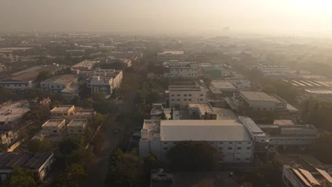 Warehouse dominates the foreground, against the gritty, hazy background Stock Footage 330326074