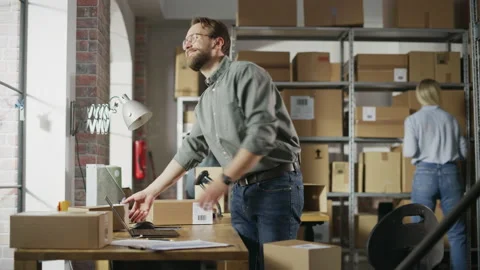 Warehouse Employee Registering Parcel Using Laptop Stock Footage 218419853