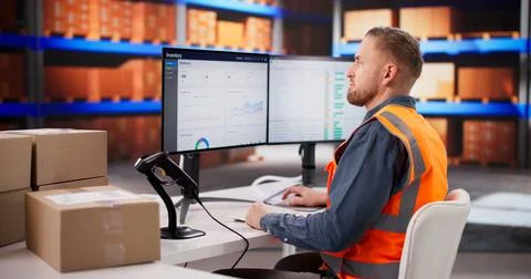 Warehouse Employee Using Barcode Scanner To Update Parcel Inventory In Logist Stock Photos