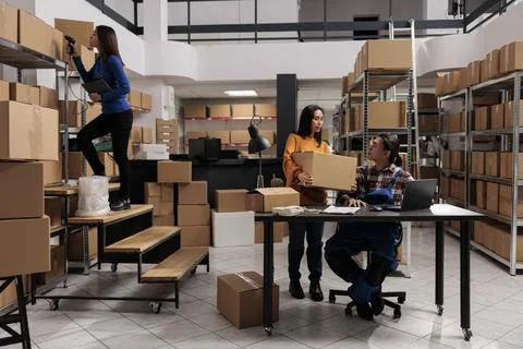 Warehouse employees doing parcel quality control and stock inventory Stock Photos