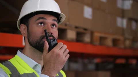 Warehouse engineer using radio and tablet at work Video stock 161951379