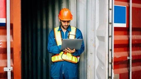 Warehouse engineer worker working at industrial container yard Stock Photos
