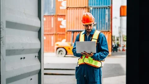 Warehouse engineer worker working at industrial container yard Stock Photos