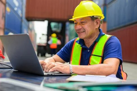 Warehouse engineer working at container yard Stock Photos