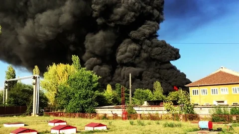 Warehouse engulfed in raging fire with huge column of smoke Stock Footage 78492568