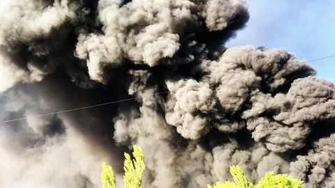 Warehouse engulfed in raging fire with huge column of smoke Stock Footage 78492808