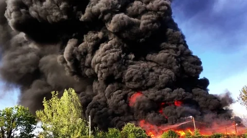 Warehouse engulfed in raging fire with huge column of smoke Stock Footage 78494374