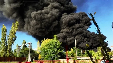 Warehouse engulfed in raging fire with huge column of smoke Stock Footage 78494447