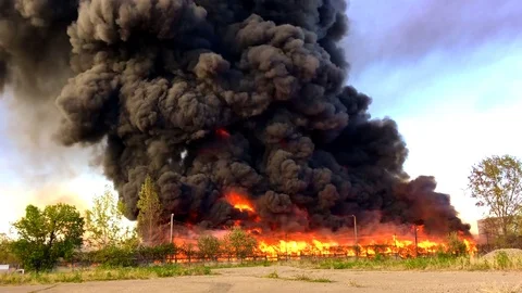 Warehouse engulfed in raging fire with huge column of smoke Stock Footage 78494461