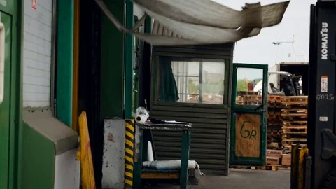 Warehouse Entrance. Loader Getting Out of Building. Male Worker Driving Moto Stock Footage 73823247