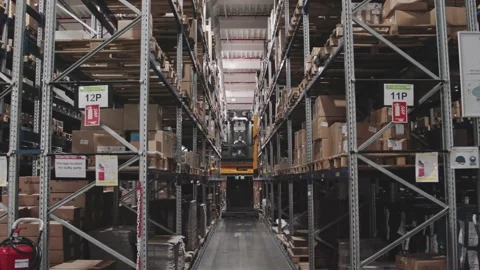 Warehouse Forklift Driver Between Racks Shelves Working with boxes Preparing ord Stock Footage 142135515